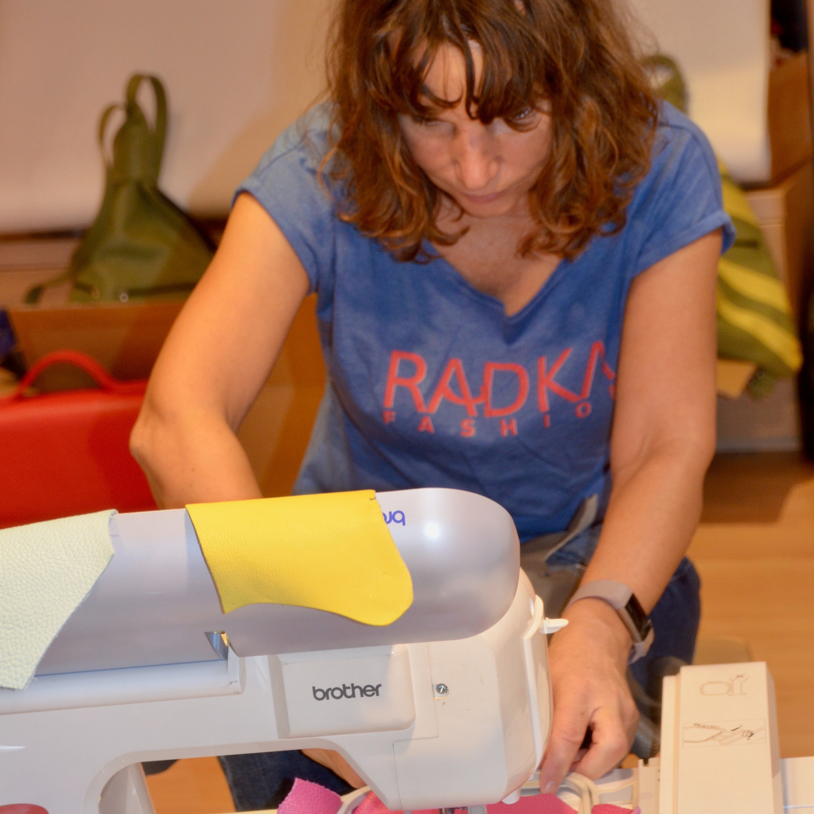woman with a sewing machine at her atelier