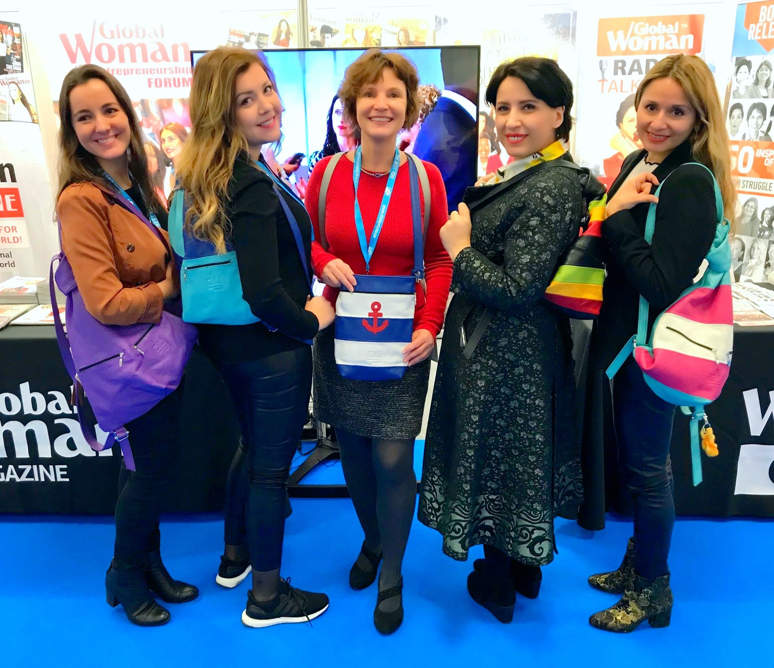 four women from global Woman wearing leather backpacks
