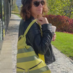 Green leathre backack wearing by woman in the city