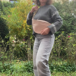 beige leather fanny bag bum bag presented by a woman