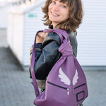 purple leather rucksack with angel wings