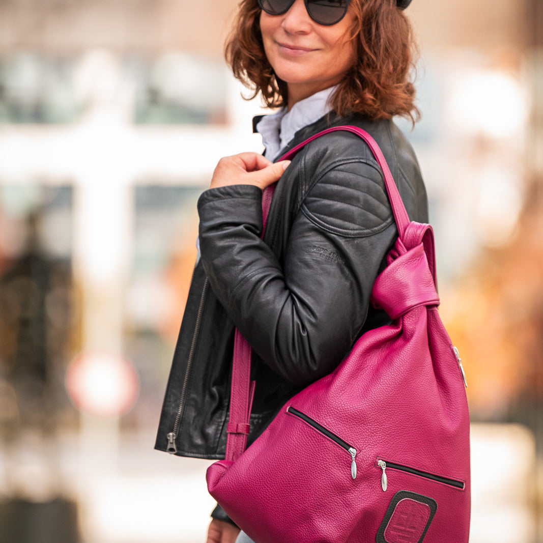 woman with a pink leather bag on her shoulder