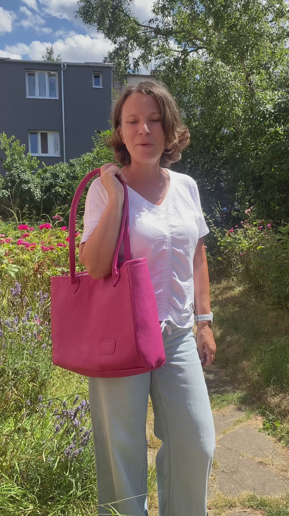 Leather tote bag wearing by woman outside in the city